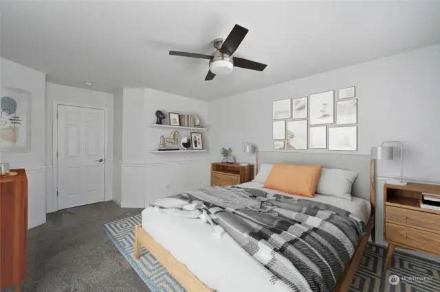 Spacious master bedroom with walk-in closet, wall to wall carpet, a ceiling fan and wainscoting.  Lovely master bath is attached.  Photos are virtual staging.