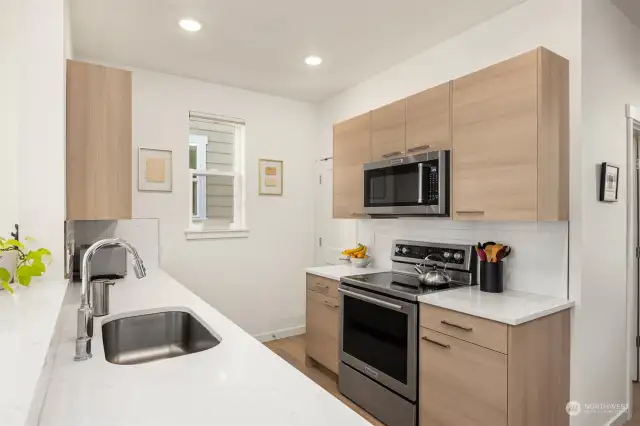 Undermount stainless steel sink, built in microwave over range. Walk in pantry.