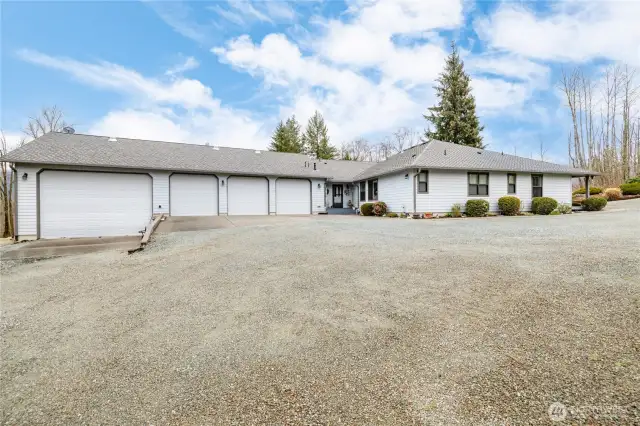 3 car garage plus RV garage.  RV garage is 20' wide 36' long and the door is 13' high x 18' wide.  There is more parking on the left side of the RV garage.