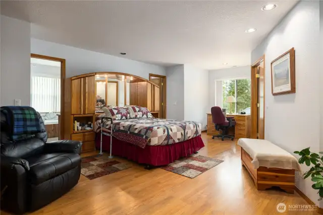 Primary bedroom is large and has two doors into the primary bathroom