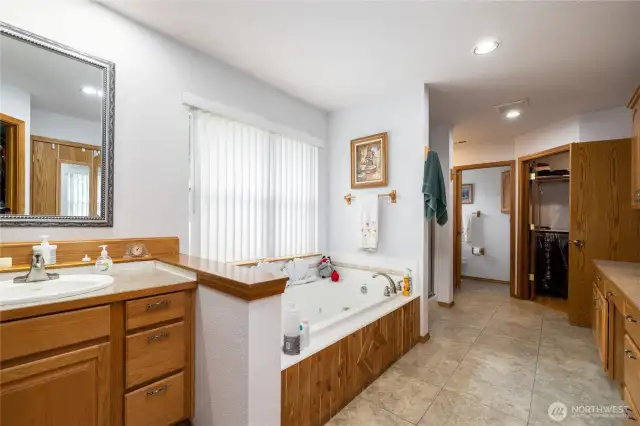 Primary bathroom has double separate sinks, double separate toilets, a jetted tub plus a shower and a built in counter.