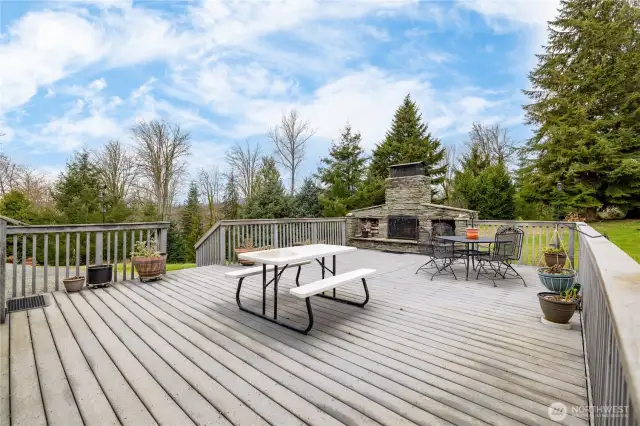 Backyard deck with fireplace made with hand cut stone.