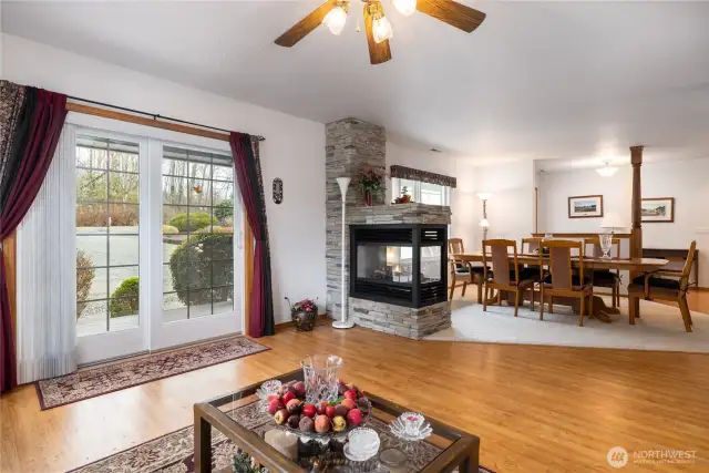 Double fireplace is run by propane and has a fan to heat this area of the home.  Formal dining room plus the family room with a sliding glass door to let in natural light.