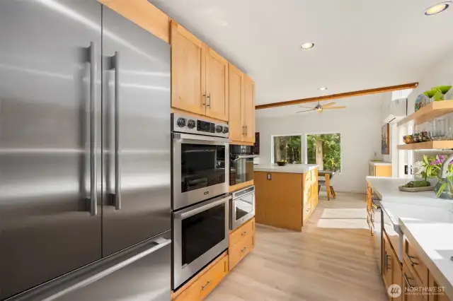 The dreamiest appliance suite is a treat at this affordable price point – extra tall counter-depth Therrmador French-door fridge/freezer, Dacor double oven, and Dacor steam/convection oven are visible here.