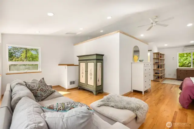This side of the bedroom is flanked by windows looking into the back yard on 2 sides, and a propane fireplace in the corner (behind the camera in this shot). The far side of this shot shows the other bedroom nook. What would you do with these spaces? The options are endless!