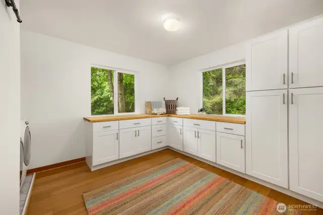 Popping back downstairs, you’ll find this functional laundry(+) room that everyone needs! Tons of counter space and fabulous light make folding laundry a pleasure. There’s ample storage for pantry overflow (CostCo and Trader Joe’s run, anyone?), cleaning supplies, crafting, and more!