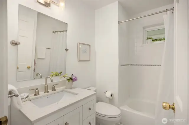 Adjacent to the front hall and just steps from the home’s entertaining spaces, your guests will appreciate this full bathroom.