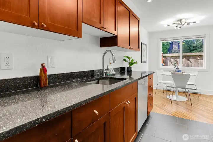 Wow! This chef's kitchen has all the bells and whistles. Beautiful slab quartz countertops, cherry cabinets. Ceramic tile floor for easy cleaning. Deep stainless sink.