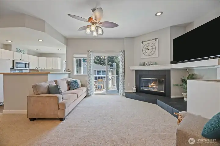 Look how inviting this living space is. Wood burning fireplace with a large storage area next to it comes in super handy. Open space to fit a big television. Updated fan helps keep things cool in the summer.