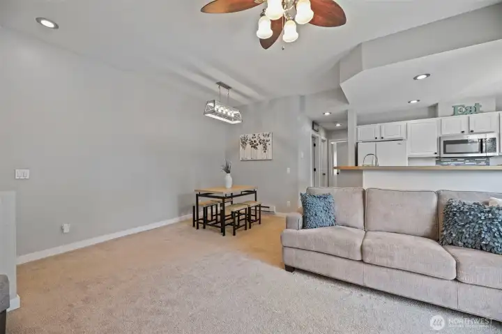 Dining area off the living space and kitchen with updated chandelier.