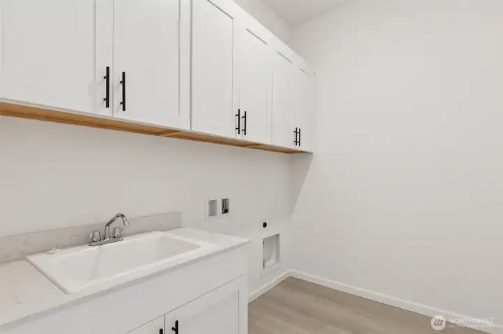 ***Actual Home *** Laundry with large deep sink, lots of cabinets for storage