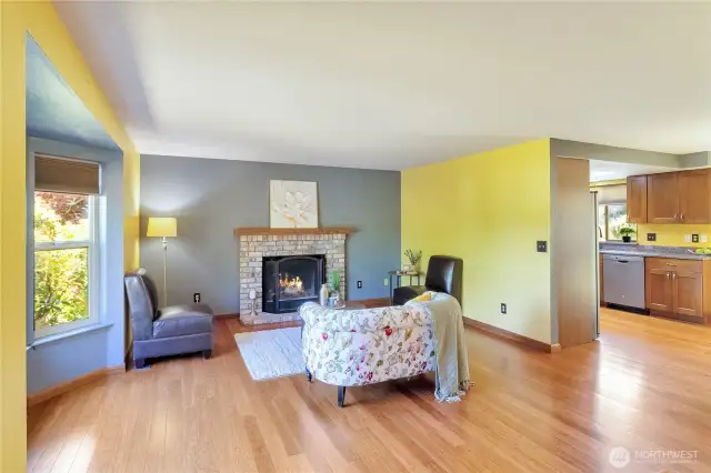 Wood burning fireplace and bay window in the living room.