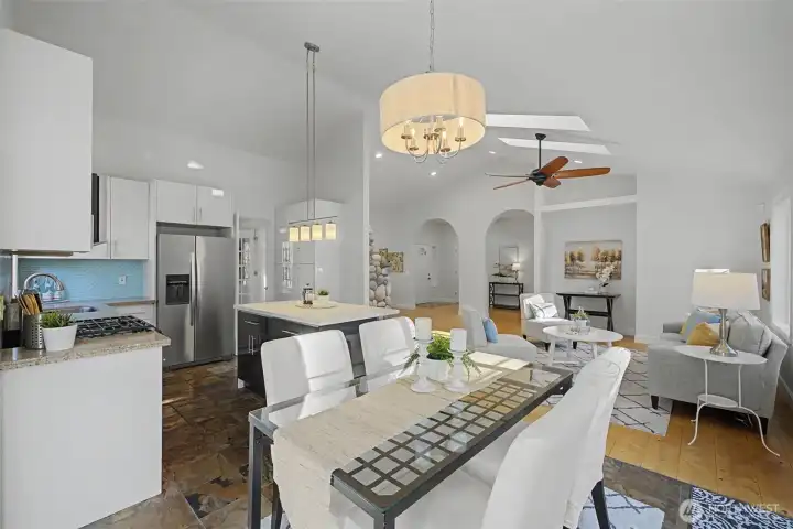 Glossy hard-surface cabinetry, quartz counters and a soft-toned tile backsplash create a clean, modern aesthetic that will age beautifully over time. Stainless steel appliances and updated lighting complete the look with both durability and style.