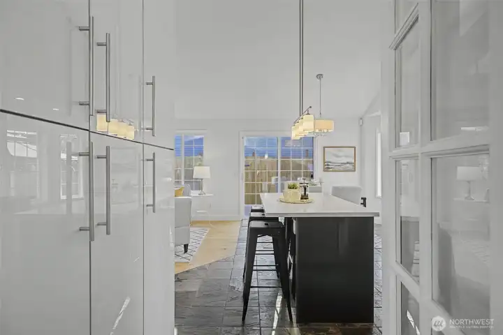 From the dining room or home office, enjoy clean sightlines into the open kitchen and adjoining great room, highlighting the home’s cohesive layout and easy flow. Glossy hard-surface cabinetry, quartz counters and modern pendant lighting create a polished, contemporary look, while warm wood floors soften the space and add warmth. This thoughtful connection keeps living, dining and entertaining spaces seamlessly integrated.