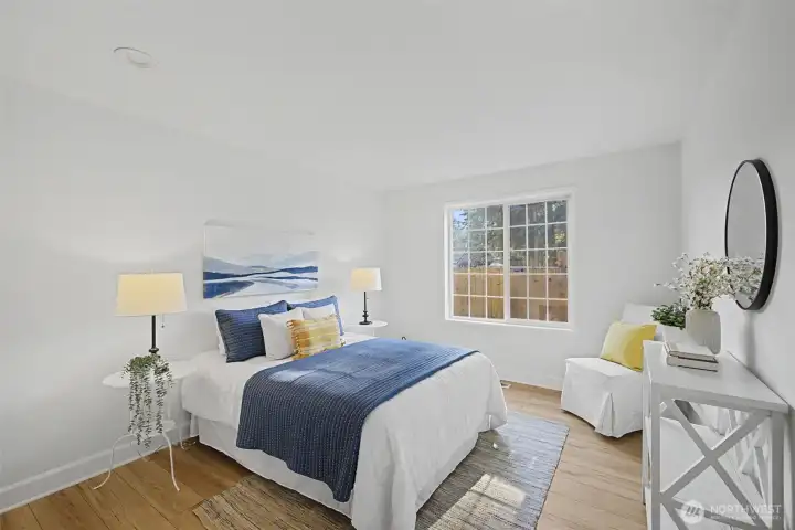 Light-Filled Secondary Bedroom Featuring Hardwood Floors, Neutral Finishes & a Generous Layout.