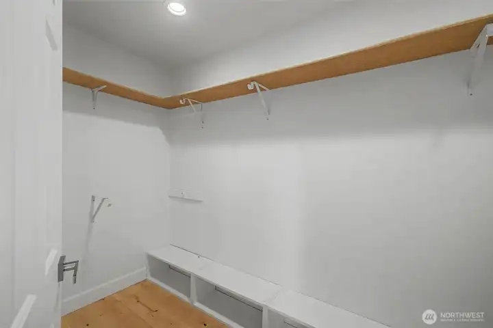 Large walk-in closet in the primary bedroom with built-in shelving and plenty of hanging space.