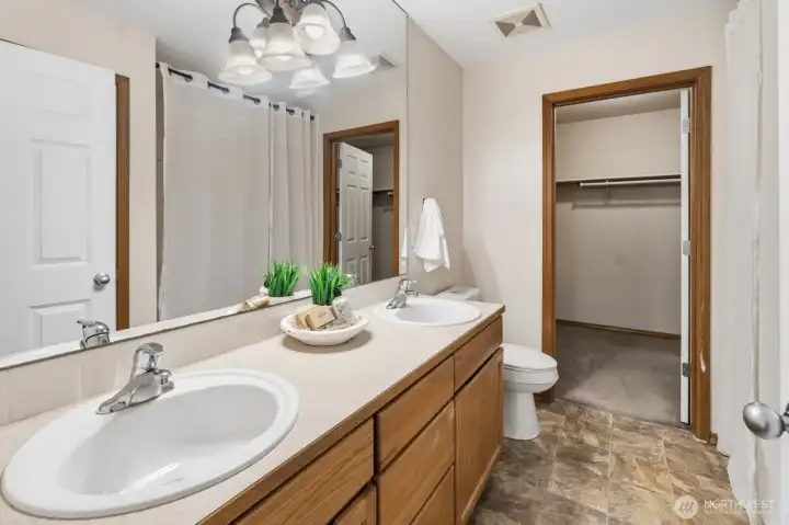 The primary suite features its own private bath and a generous walk-in closet