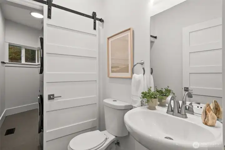 On the main floor:  Half bath for guests and laundry hidden behind with custom cabinetry.