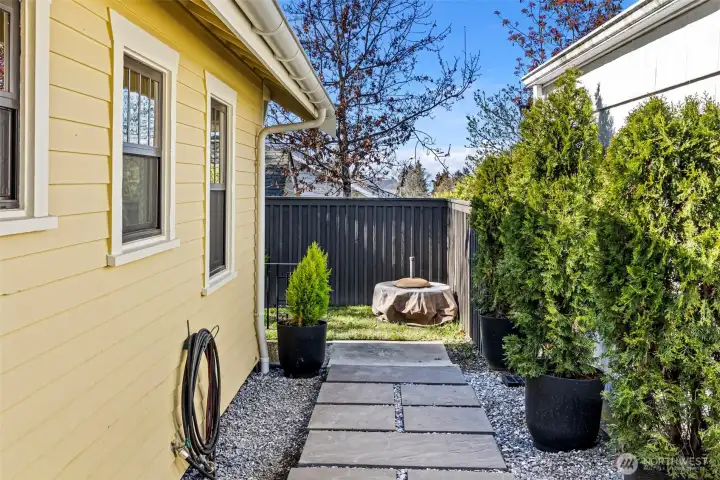 More of the side yard leading to stairs to access the crawlspace.