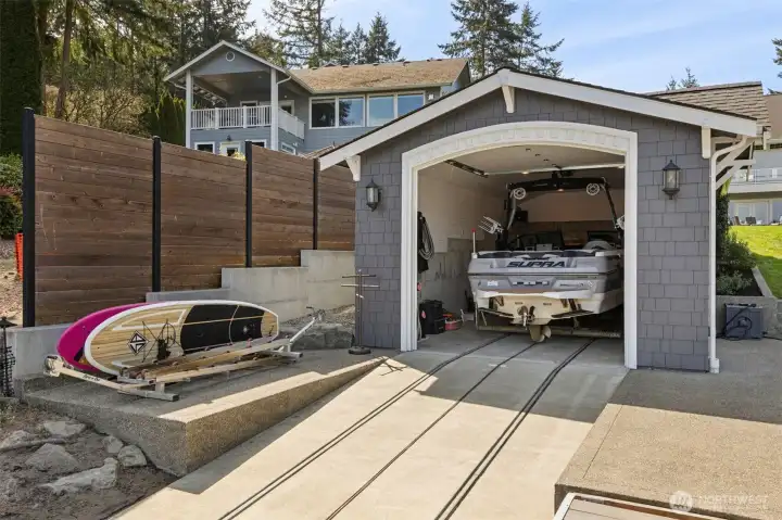 This isn’t your basic boathouse situation. The built-in lift system lets you bring the boat in with ease, no awkward maneuvering, no stress, just a clean glide into place. Off to the side, there’s room for all the extras, kayaks, paddleboards, the things you actually use when you live on the water. It’s organized, intentional, and built to handle real use without looking rough around the edges. This boathouse is only a couple years old and so very rare on the lake.  The inside is shiplap too. Don't miss that extra detail.