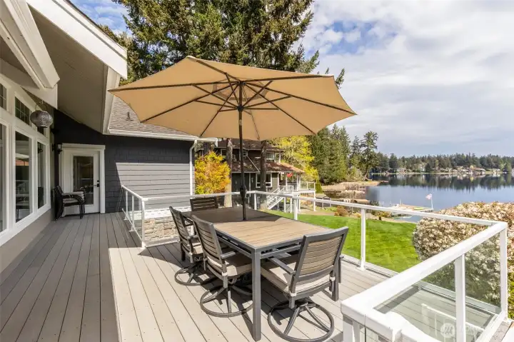 The EverGrain composite decking keeps things low-maintenance and high-performance, no splintering, cracking, or constant upkeep, just show up and enjoy it. The glass railing disappears into the background, leaving you with uninterrupted views across your 53 feet of waterfront and beyond. There’s plenty of space for outdoor dining when the weather’s playing nice, and a covered section that lets you stay out here even when it’s not. Rainy morning coffee, crisp fall evenings, it all works.