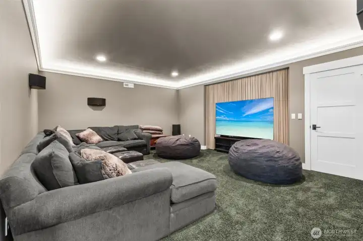 A proper movie room, not an afterthought. Tucked away in the basement, this space is all about comfort and relaxation. The soft carpeting underfoot and subtle LED crown lighting set the tone without overdoing it, while the recessed screen area keeps the setup streamlined and polished. There’s room here for real seating, not just squeezing onto a couch, so everyone gets a good spot. Whether it’s movies, game day, or a binge-watch situation, this room is ready for it.  There is even extra storage space in the closet seen straight ahead.