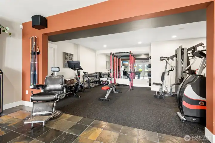 Right now it’s a workout zone, but it doesn’t have to stay that way. The cushioned flooring is a win for anything active, workouts, play space, even a laid-back lounge setup if that’s more your speed. The wall of mirrors adds light and energy to the room, keeping it from feeling like a basement at all. And with the built-in sound system overhead, you’re not missing out on the vibe no matter how you use it. Gym today, playroom tomorrow, yoga retreat next week, it’s flexible and ready for whatever phase you’re in.