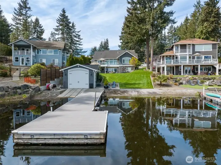 From the water, you really see what sets this one apart. The dock leads cleanly into the boathouse and patio seating area, then it’s just a gentle, grassy slope all the way up to the house. No stairs, no switchbacks, no “watch your step” situation. You’ve got 53 feet of waterfront with a true sandy beach entry, which is rare on Long Lake. Most properties make you work to get to the water. This one just lets you walk right in. Easy for kids, easy for guests, easy for everyday life.