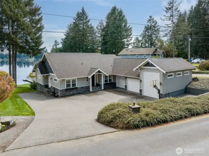 Pulling in feels easy here. The wide driveway handles multiple vehicles without turning into a puzzle, and guest parking is actually a non-issue. The front yard is tidy and well kept, with landscaping that feels maintained but not high-maintenance. The three-tone exterior gives the home a layered, updated look that stands out in a subtle way. With over a third of an acre, there’s room to enjoy without feeling boxed in. And the street itself reflects it, homes along Long Lake Drive carry that same sense of care, which is always a good sign.