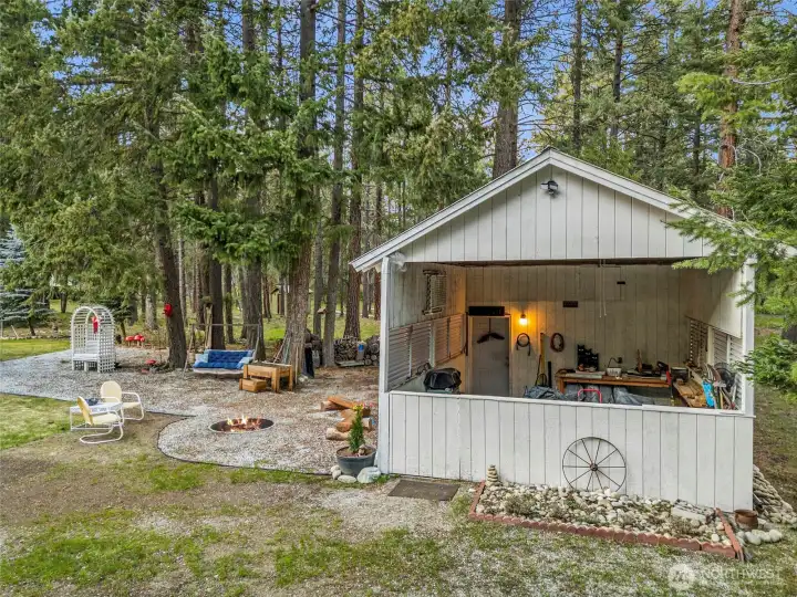 Detached carport/workshop with bonus finished room and half bath.