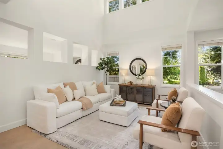 Timeless formal living room with soaring ceilings and abundant natural light, creating an impressive yet inviting gathering space