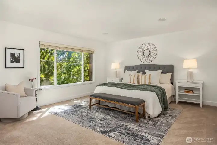 Upper Level Primary retreat with French doors, in-wall speakers, and partial Cascade Mountain views.