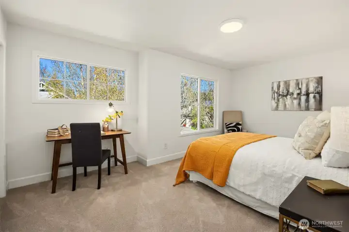 Bright and welcoming guest bedroom designed with both style and functionality in mind.