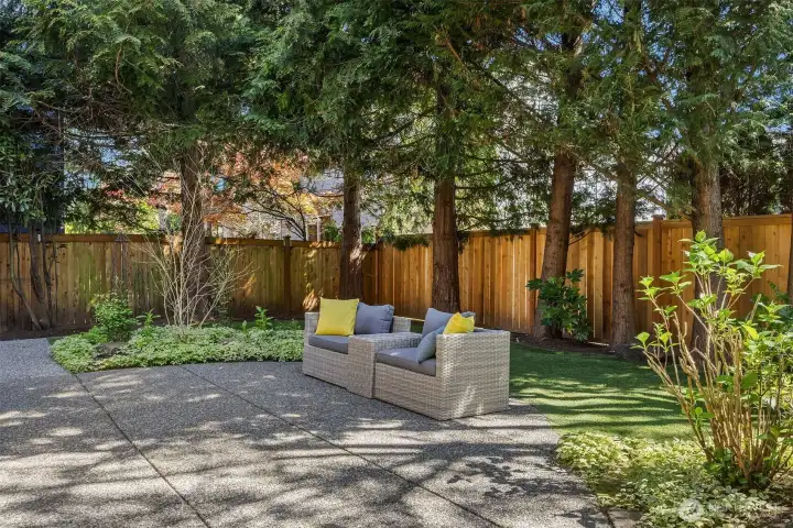 Fully fenced backyard featuring elegant flagstone pavers—offering both privacy and a beautifully designed outdoor living space