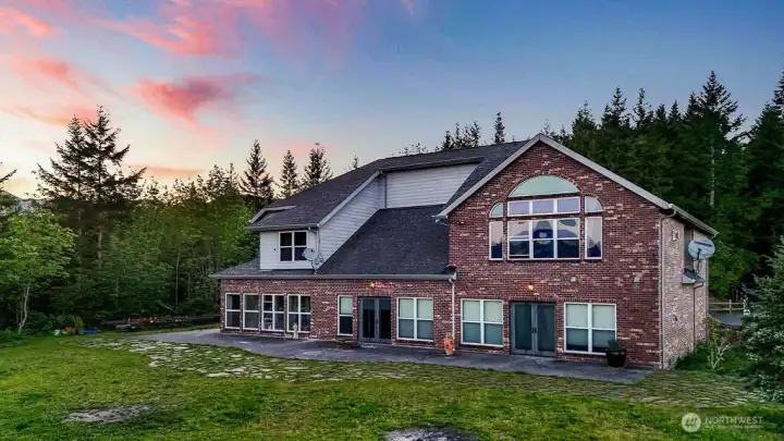 Low maintenance brick exterior. Solarium at the left end of the first floor.