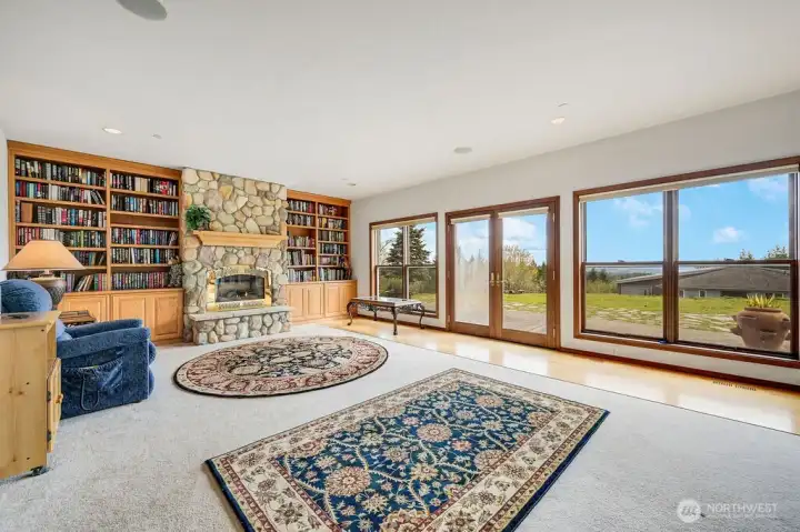 Living area with custom fireplace and built-in shelving.
