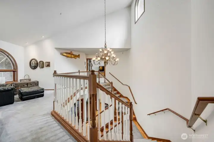 Custom staircase creates a graceful transition to the upper floor bedrooms.