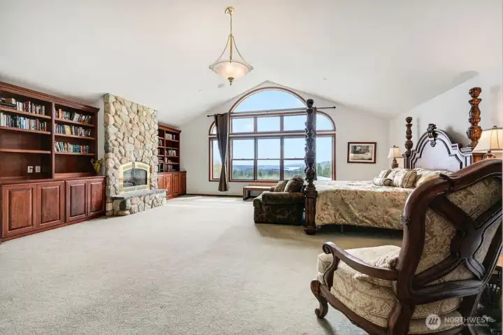 Spacious master suite with view of Quilcene Bay and the Hood Canal. Propane fireplace and built-in cabinetry.