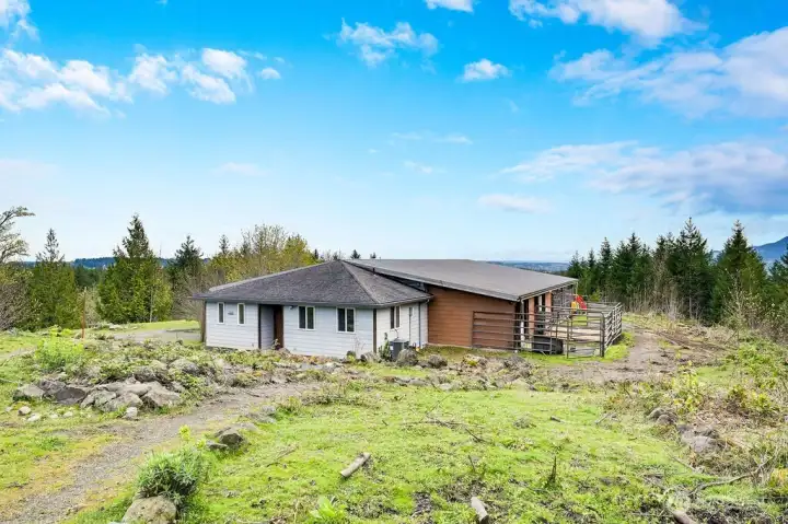 Barn/shop with, stables, 6+ car garage, office area, kitchenette and 3/4 bath.