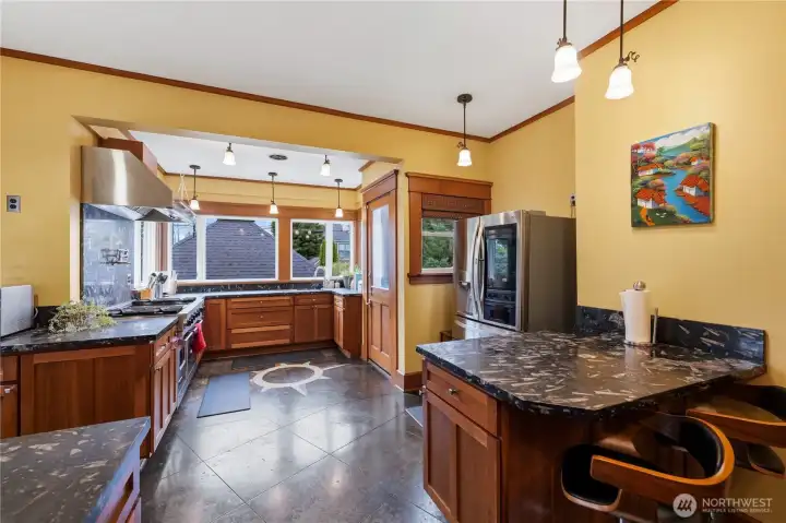 Gourmet kitchen with marble counters and heated concrete floors