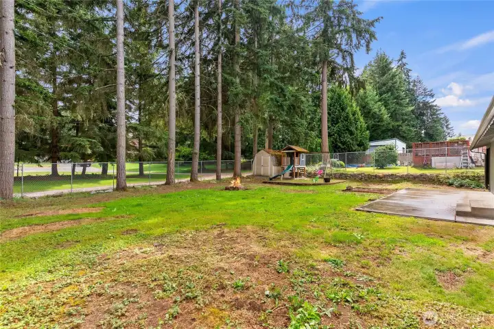 Firepit, shed and playground.