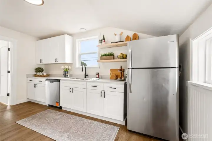 The fully remodeled kitchen shines with white Shaker cabinetry, stainless appliances, and fresh finishes. Ideal for buyers seeking a move-in-ready home with modern updates. The fully remodeled kitchen shines with white Shaker cabinetry, stainless appliances, and fresh finishes. Ideal for buyers seeking a move-in-ready home with modern updates.