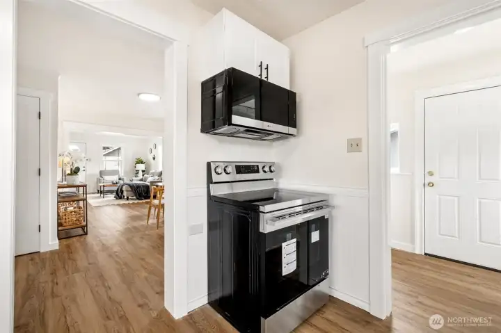 New appliances include; range/oven, dishwasher, microwave. View to utility room at right of photo. New appliances include; range/oven, dishwasher, microwave. View to utility room at right of photo.