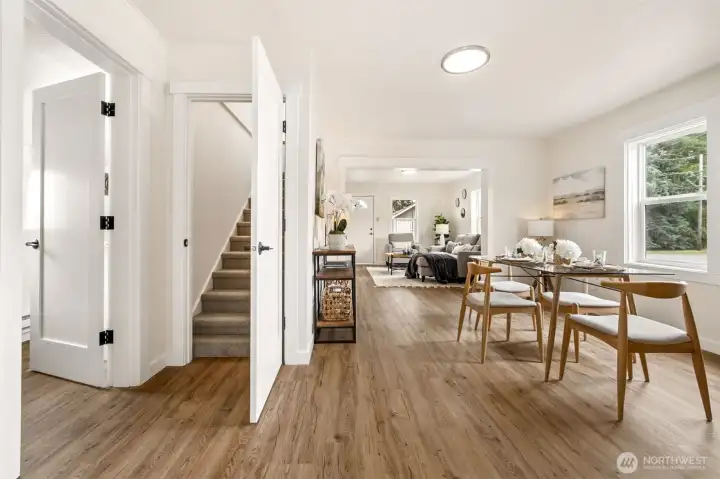 A bright, connected view from the dining room into the living room showcases the home’s easy flow and warm, open layout. The staircase leading to the private primary suite adds charm and highlights how comfortably the main level lives. Newly remodeled with interior doors, trim, paint, LVP, carpet, kitchen and bath! A bright, connected view from the dining room into the living room showcases the home’s easy flow and warm, open layout. The staircase leading to the private primary suite adds charm and highlights how comfortably the main level lives. Newly remodeled with interior doors, trim, paint, LVP, carpet, kitchen and bath!