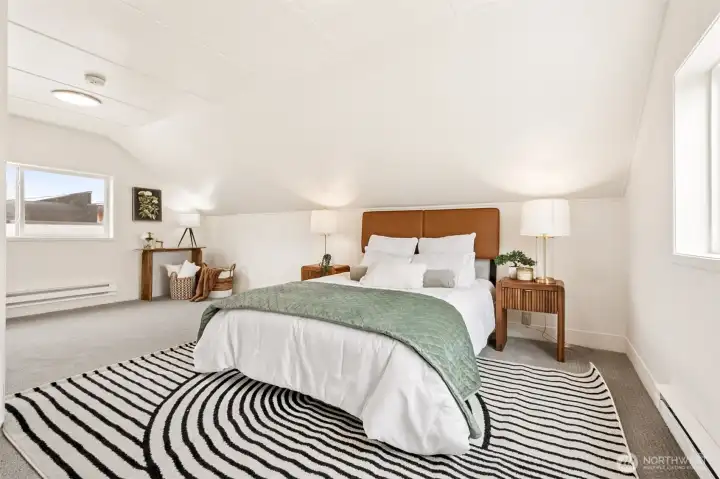 The upstairs primary bedroom offers a generous, retreat-like space with room for multiple furniture layouts. Soft new carpet underfoot adds comfort and warmth, making the suite feel inviting from the moment you step in. Its size and privacy create a true getaway within the home. The upstairs primary bedroom offers a generous, retreat-like space with room for multiple furniture layouts. Soft new carpet underfoot adds comfort and warmth, making the suite feel inviting from the moment you step in. Its size and privacy create a true getaway within the home.