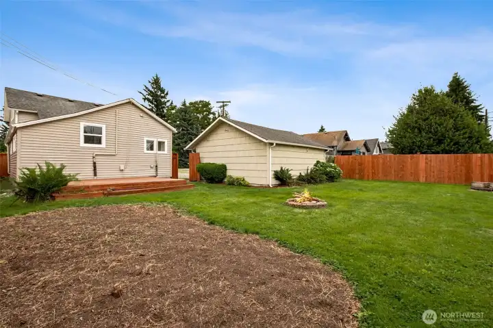 A large, fully fenced backyard offers space to live, play, and entertain with ease. The entertainment-sized deck is perfect for gatherings, while the garden area and fire pit create inviting spots for relaxing outdoors and enjoying the seasons. A large, fully fenced backyard offers space to live, play, and entertain with ease. The entertainment-sized deck is perfect for gatherings, while the garden area and fire pit create inviting spots for relaxing outdoors and enjoying the seasons.