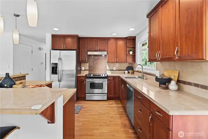 Lovely warm cabinets and stone counters Lovely warm cabinets and stone counters