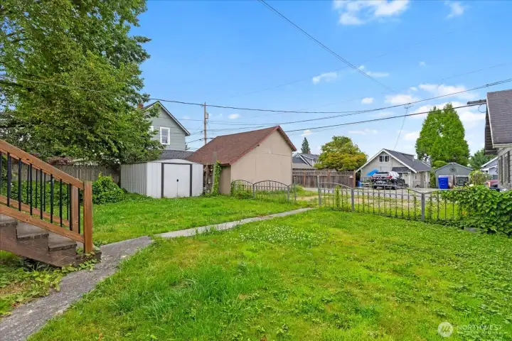 Large backyard complete with storage shed, garage and private alley parking. Large backyard complete with storage shed, garage and private alley parking.