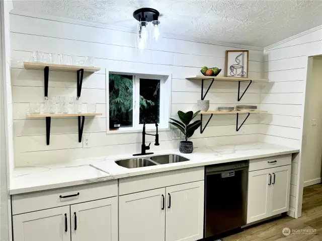 Granite and shaker cabinets. floating shelves.