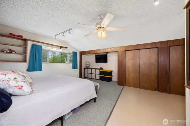 The primary suite has a large wall of closet space which is great for storage as well.